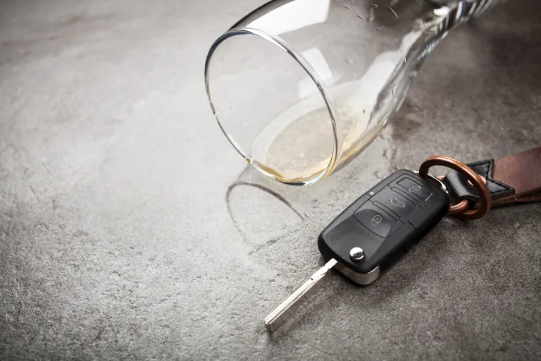Drunk driving concept - spilled beer and car keys on a table